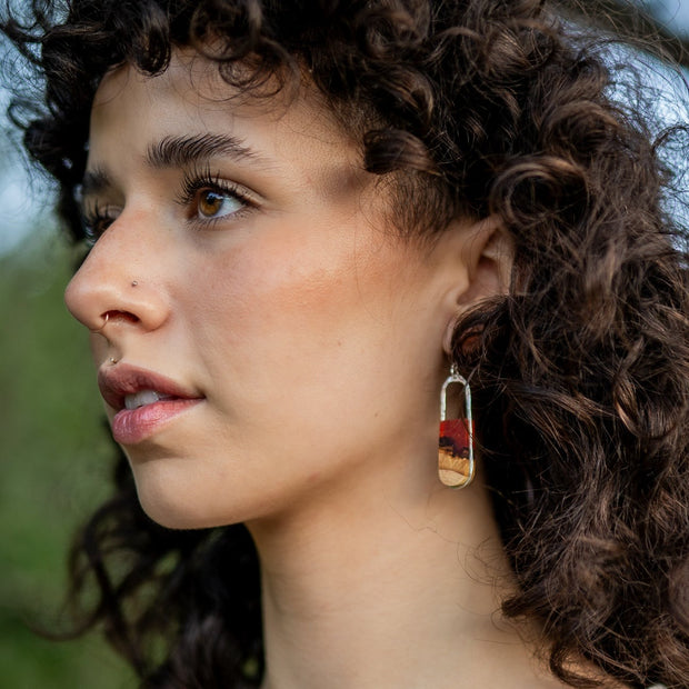 Hand-cut basswood topped with hand-tinted resin and framed in your choice of hand-forged sterling silver or 14k gold-fill. These dainty pieces measure 1.75" from the bottom of the ear wire to the bottom of the earring and .5" from side-to-side.