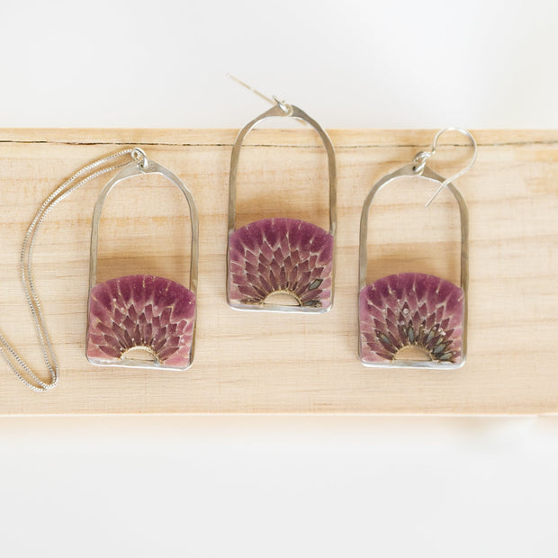 Teasel cross-section suspended in hand-tinted resin, framed in your choice of hand-forged sterling silver or 14k gold-fill. This arched pendant is 1.75" long and just under 1" wide with a total length of 16" and a 1.5" extender.