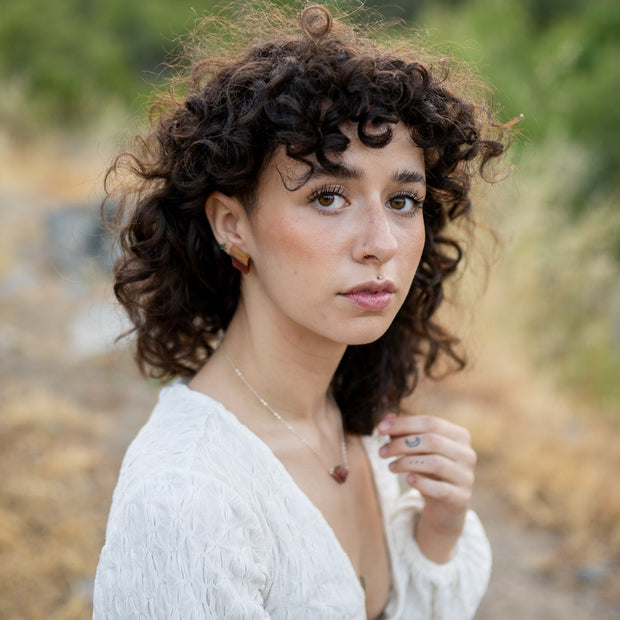 Hand-cut bourbon barrel stave with hand-tinted resin and finished with sterling silver posts. These bourbon babies measure 1" tall and .5" wide.