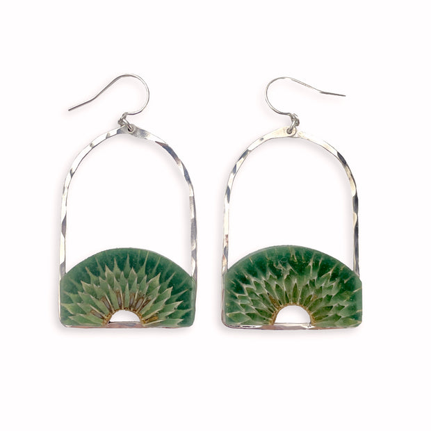 Teasel cross-section suspended in hand-tinted resin, framed in your choice of hand-forged sterling silver or 14k gold-fill. These pieces measure just under 2" from the bottom of the ear wire to the bottom of the earring and 1.25" from side-to-side.