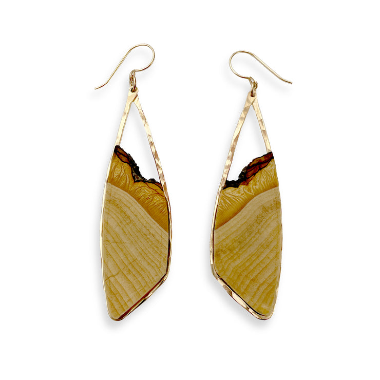 Hand-cut basswood framed in your choice of hand-forged sterling silver or 14k gold-fill. These woody pieces measure 2.5" from the bottom of the ear wire to the bottom of the earring and just under 1" from side-to-side. 