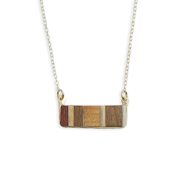 This piece is inspired and sourced from the scraps of local woodworkers. Each necklace will have a slightly different wood pattern and type. Framed in your choice of sterling silver or 14k gold-fill.  Buy One Plant One - One tree planted for every Branch+Barrel piece sold!