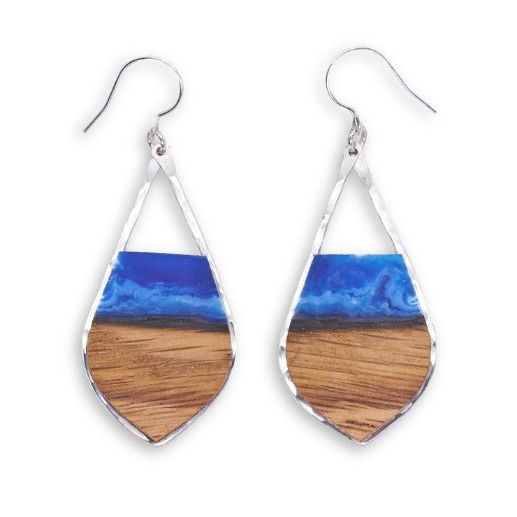 Branch and Barrel “Aurora” - Pointed Teardrop Bourbon Barrel Stave Earrings  Hand cut reclaimed oak bourbon barrel stave topped with a hand-tinted blue resin and framed in hand forged sterling-silver or 14k gold-fill.  Buy One, Plant One - One tree planted for every Branch+Barrel piece sold.